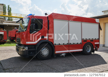 A state-of-the-art firetruck, equipped with advanced rescue technology, stands ready with its skilled firefighting team, prepared to intervene and respond rapidly to emergencies, ensuring the safety 127567012