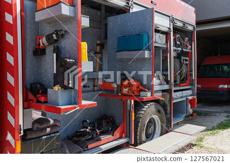 Close-up of essential firefighting equipment on a modern firetruck, showcasing tools and gear ready for emergency response to hazardous fire situations Close-up of essential firefighting equipment on a modern firetruck, showcasing tools and gear ready for emergency response to hazardous fire situations 127567021