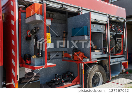 Close-up of essential firefighting equipment on a modern firetruck, showcasing tools and gear ready for emergency response to hazardous fire situations Close-up of essential firefighting equipment on a modern firetruck, showcasing tools and gear ready for emergency response to hazardous fire situations 127567022