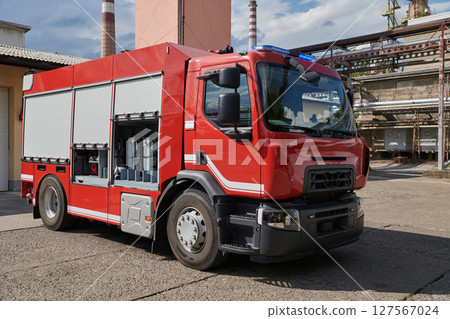 A state-of-the-art firetruck, equipped with advanced rescue technology, stands ready with its skilled firefighting team, prepared to intervene and respond rapidly to emergencies, ensuring the safety A state-of-the-art firetruck, equipped with advanced rescue technology, stands ready with its skilled firefighting team, prepared to intervene and respond rapidly to emergencies, ensuring the safety 127567024