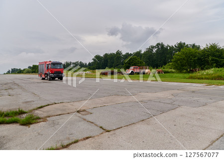 In this captivating scene, a state-of-the-art firetruck, equipped with advanced rescue technology, stands ready with its skilled firefighting team, prepared to intervene and respond rapidly to 127567077