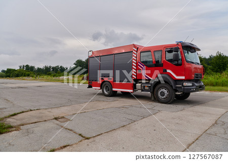 In this captivating scene, a state-of-the-art firetruck, equipped with advanced rescue technology, stands ready with its skilled firefighting team, prepared to intervene and respond rapidly to In this captivating scene, a state-of-the-art firetruck, equipped with advanced rescue technology, stands ready with its skilled firefighting team, prepared to intervene and respond rapidly to 127567087