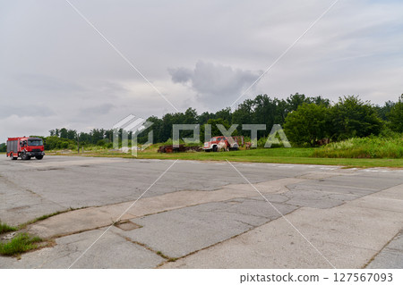 In this captivating scene, a state-of-the-art firetruck, equipped with advanced rescue technology, stands ready with its skilled firefighting team, prepared to intervene and respond rapidly to 127567093