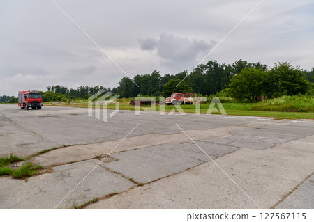 In this captivating scene, a state-of-the-art firetruck, equipped with advanced rescue technology, stands ready with its skilled firefighting team, prepared to intervene and respond rapidly to 127567115