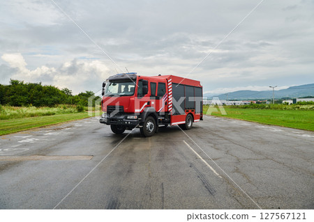 In this captivating scene, a state-of-the-art firetruck, equipped with advanced rescue technology, stands ready with its skilled firefighting team, prepared to intervene and respond rapidly to In this captivating scene, a state-of-the-art firetruck, equipped with advanced rescue technology, stands ready with its skilled firefighting team, prepared to intervene and respond rapidly to 127567121