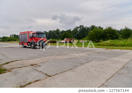 In this captivating scene, a state-of-the-art firetruck, equipped with advanced rescue technology, stands ready with its skilled firefighting team, prepared to intervene and respond rapidly to In this captivating scene, a state-of-the-art firetruck, equipped with advanced rescue technology, stands ready with its skilled firefighting team, prepared to intervene and respond rapidly to 127567144