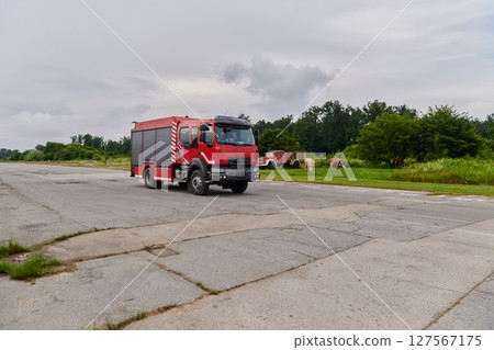 In this captivating scene, a state-of-the-art firetruck, equipped with advanced rescue technology, stands ready with its skilled firefighting team, prepared to intervene and respond rapidly to In this captivating scene, a state-of-the-art firetruck, equipped with advanced rescue technology, stands ready with its skilled firefighting team, prepared to intervene and respond rapidly to 127567175