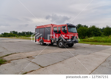 In this captivating scene, a state-of-the-art firetruck, equipped with advanced rescue technology, stands ready with its skilled firefighting team, prepared to intervene and respond rapidly to In this captivating scene, a state-of-the-art firetruck, equipped with advanced rescue technology, stands ready with its skilled firefighting team, prepared to intervene and respond rapidly to 127567231