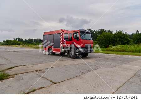 In this captivating scene, a state-of-the-art firetruck, equipped with advanced rescue technology, stands ready with its skilled firefighting team, prepared to intervene and respond rapidly to In this captivating scene, a state-of-the-art firetruck, equipped with advanced rescue technology, stands ready with its skilled firefighting team, prepared to intervene and respond rapidly to 127567241