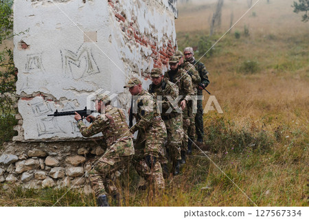 In a high stakes mission, a specialized military unit executes a tactical operation to secure a dangerous house where terrorists are believed to be hiding, showcasing precision and coordinated 127567334
