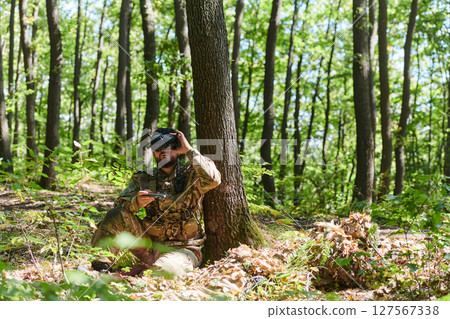 An elite soldier, equipped with state-of-the-art VR glasses, adeptly maneuvers a military drone, showcasing the seamless integration of cutting-edge technology in modern warfare 127567338