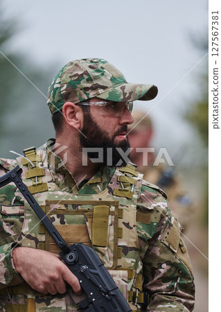 Elite soldier exudes focused determination and readiness, geared up for a perilous military operation, capturing the essence of courage and professionalism in the face of imminent danger Elite soldier exudes focused determination and readiness, geared up for a perilous military operation, capturing the essence of courage and professionalism in the face of imminent danger 127567381