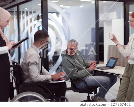 Young group of business people brainstorming together in a startup space, discussing business projects, investments, and solving challenges. 127567461