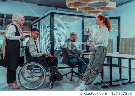Young group of business people brainstorming together in a startup space, discussing business projects, investments, and solving challenges. 127567599