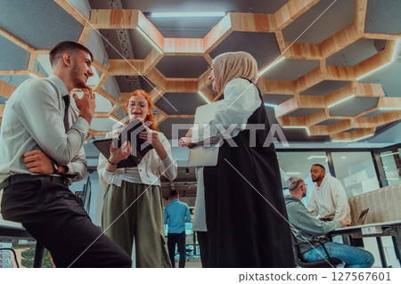 Young group of business people brainstorming together in a startup space, discussing business projects, investments, and solving challenges. 127567601