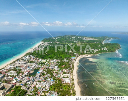 Coastline with white sand beaches and clear turquoise sea waters and waves in Boracay, Philippines. Coastline with white sand beaches and clear turquoise sea waters and waves in Boracay, Philippines. 127567651