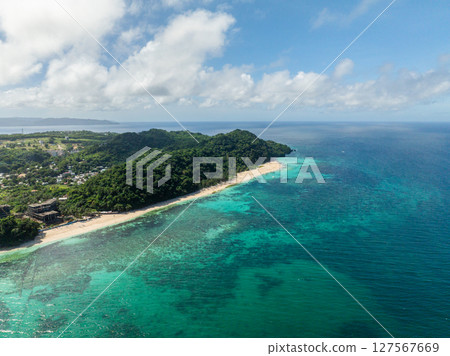 Coastline with white sandy and clear turquoise sea water and waves. Puka Beach. Boracay, Philippines. Coastline with white sandy and clear turquoise sea water and waves. Puka Beach. Boracay, Philippines. 127567669