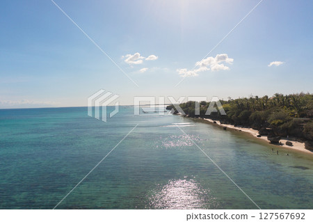 Scenic landscape of beach under the sun. Turquoise water and corals in sandy beach with rocks. Bantayan Island, Philippines. Cebu. Scenic landscape of beach under the sun. Turquoise water and corals in sandy beach with rocks. Bantayan Island, Philippines. Cebu. 127567692