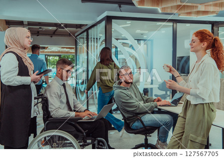 Young group of business people brainstorming together in a startup space, discussing business projects, investments, and solving challenges. 127567705