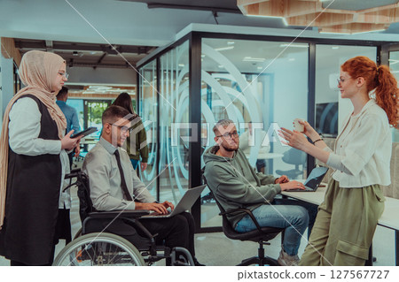 Young group of business people brainstorming together in a startup space, discussing business projects, investments, and solving challenges. 127567727