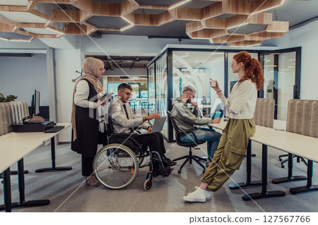 Young group of business people brainstorming together in a startup space, discussing business projects, investments, and solving challenges. Young group of business people brainstorming together in a startup space, discussing business projects, investments, and solving challenges. 127567766