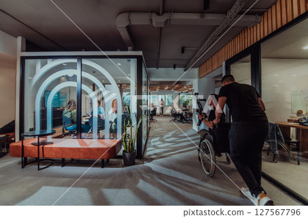 In a modern office, a professional team of videographers captures the essence of creativity and innovation as they film a group of young entrepreneurs, symbolizing collaboration and ambition in the 127567796