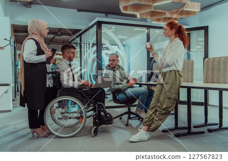 Young group of business people brainstorming together in a startup space, discussing business projects, investments, and solving challenges. 127567823