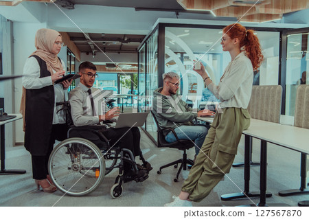 Young group of business people brainstorming together in a startup space, discussing business projects, investments, and solving challenges. 127567870