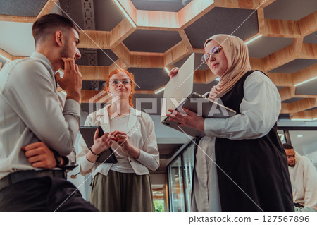 Young group of business people brainstorming together in a startup space, discussing business projects, investments, and solving challenges. 127567896