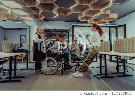 Young group of business people brainstorming together in a startup space, discussing business projects, investments, and solving challenges. 127567905