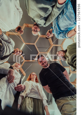 A group of young businessmen offer their hands together, symbolizing togetherness in the business world 127567936