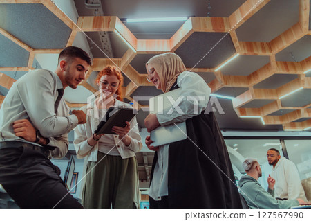 Young group of business people brainstorming together in a startup space, discussing business projects, investments, and solving challenges. 127567990