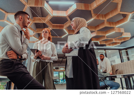 Young group of business people brainstorming together in a startup space, discussing business projects, investments, and solving challenges. 127568022