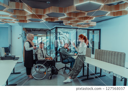 Young group of business people brainstorming together in a startup space, discussing business projects, investments, and solving challenges. 127568037