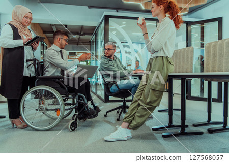 Young group of business people brainstorming together in a startup space, discussing business projects, investments, and solving challenges. 127568057