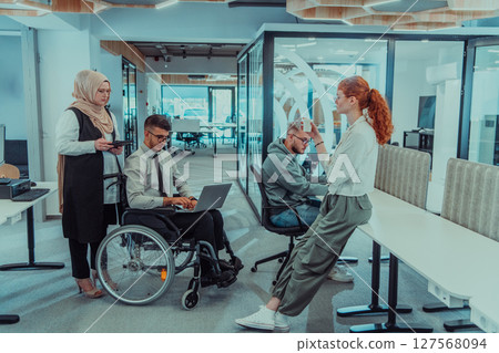 Young group of business people brainstorming together in a startup space, discussing business projects, investments, and solving challenges. Young group of business people brainstorming together in a startup space, discussing business projects, investments, and solving challenges. 127568094