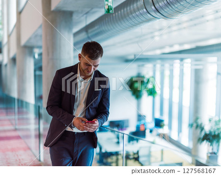In a sleek corporate setting, the young and charismatic director strides confidently down the hallway, symbolizing his dynamic leadership and the promise of continued success within the company he 127568167