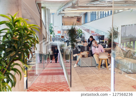 In a modern startup office, a diverse group of young professionals collaboratively tackles various business problems and challenges, surrounded by their engaged colleagues, fostering innovation and 127568236