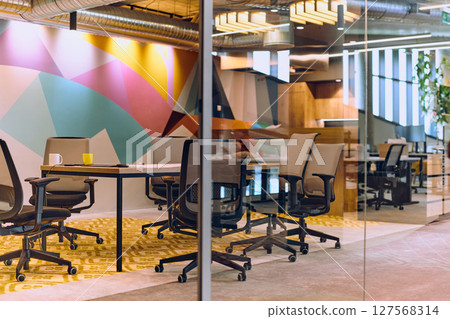 In the contemporary setting of an empty modern glass startup office, the space exudes a sleek and innovative atmosphere, ready to be filled with the potential of entrepreneurial endeavors 127568314