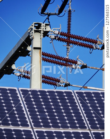 A power line with a solar panel on top of it A power line with a solar panel on top of it 127568315