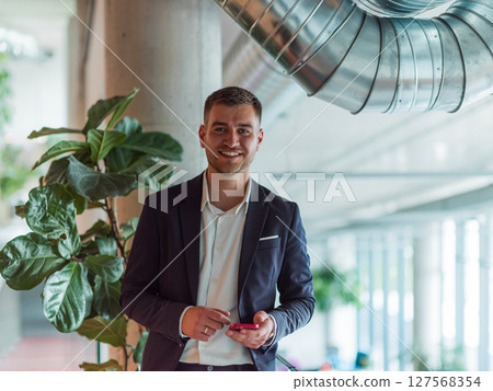 In a sleek corporate setting, the young and charismatic director strides confidently down the hallway, symbolizing his dynamic leadership and the promise of continued success within the company he 127568354