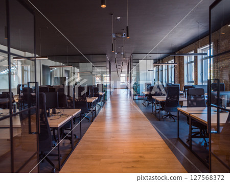 In a setting of modern, glass-walled business startup offices, the open, airy workspace reflects a contemporary and innovative ambiance, promising a dynamic environment for entrepreneurial growth In a setting of modern, glass-walled business startup offices, the open, airy workspace reflects a contemporary and innovative ambiance, promising a dynamic environment for entrepreneurial growth 127568372