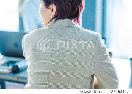 Rear view of a woman at work Rear view of a woman at work 127568442