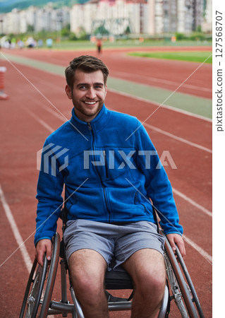 A person with disability in a wheelchair training tirelessly on the track in preparation for the Paralympic Games 127568707