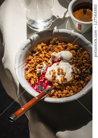 Portion of gourmet granola and yogurt bowl Portion of gourmet granola and yogurt bowl 127568860