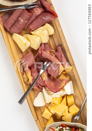 Portion of antipasti platter with cheese and meat 127568863