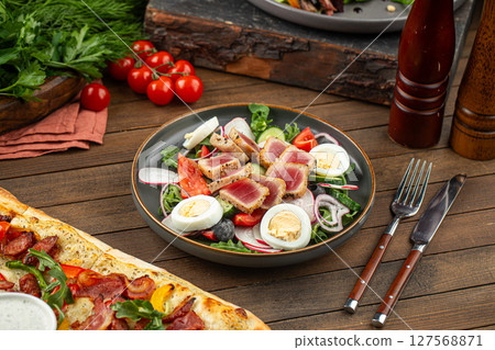 Portion of nicoise salad with tuna fish and eggs Portion of nicoise salad with tuna fish and eggs 127568871