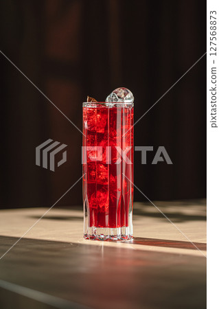 Highball glass of fresh red cocktail with mint 127568873