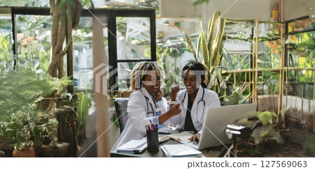 Smiling African American Female Doctors Review Results in a Flower-Filled Laboratory.Generated image 127569063
