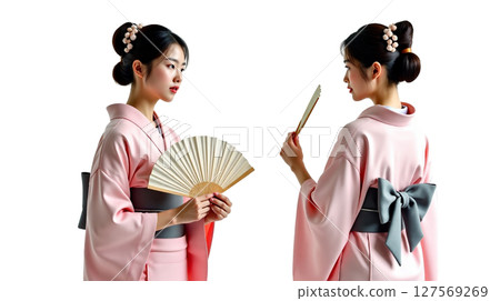 A young Japanese woman wears a modern kimono while posing in two different stances. She holds a fan, exuding grace and elegance, perfectly embodying traditional and contemporary style. 127569269